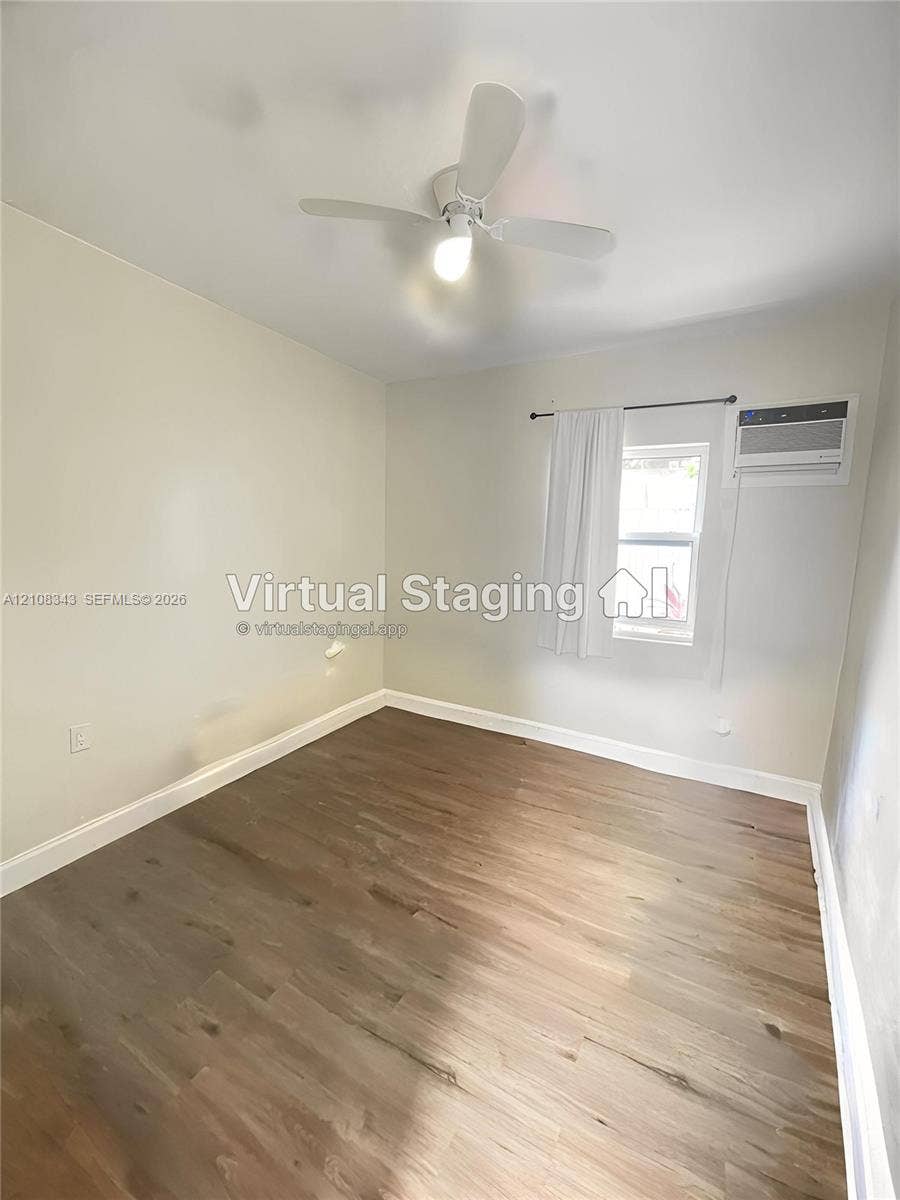 1935 Liberty Street, #3, Hollywood, Hollywood, FL 33020 Room featuring wood-finish flooring, a white ceiling fan with integrated lighting, and a wall-mounted air conditioning unit