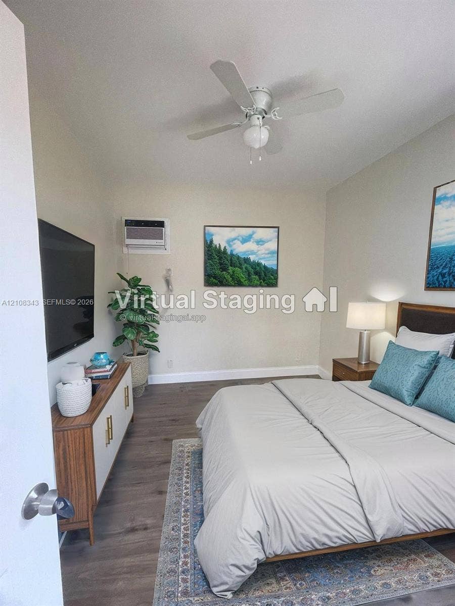 1935 Liberty Street, #3, Hollywood, Hollywood, FL 33020 Room featuring wood-finish flooring, a ceiling fan with integrated lighting, and a wall-mounted air conditioning unit