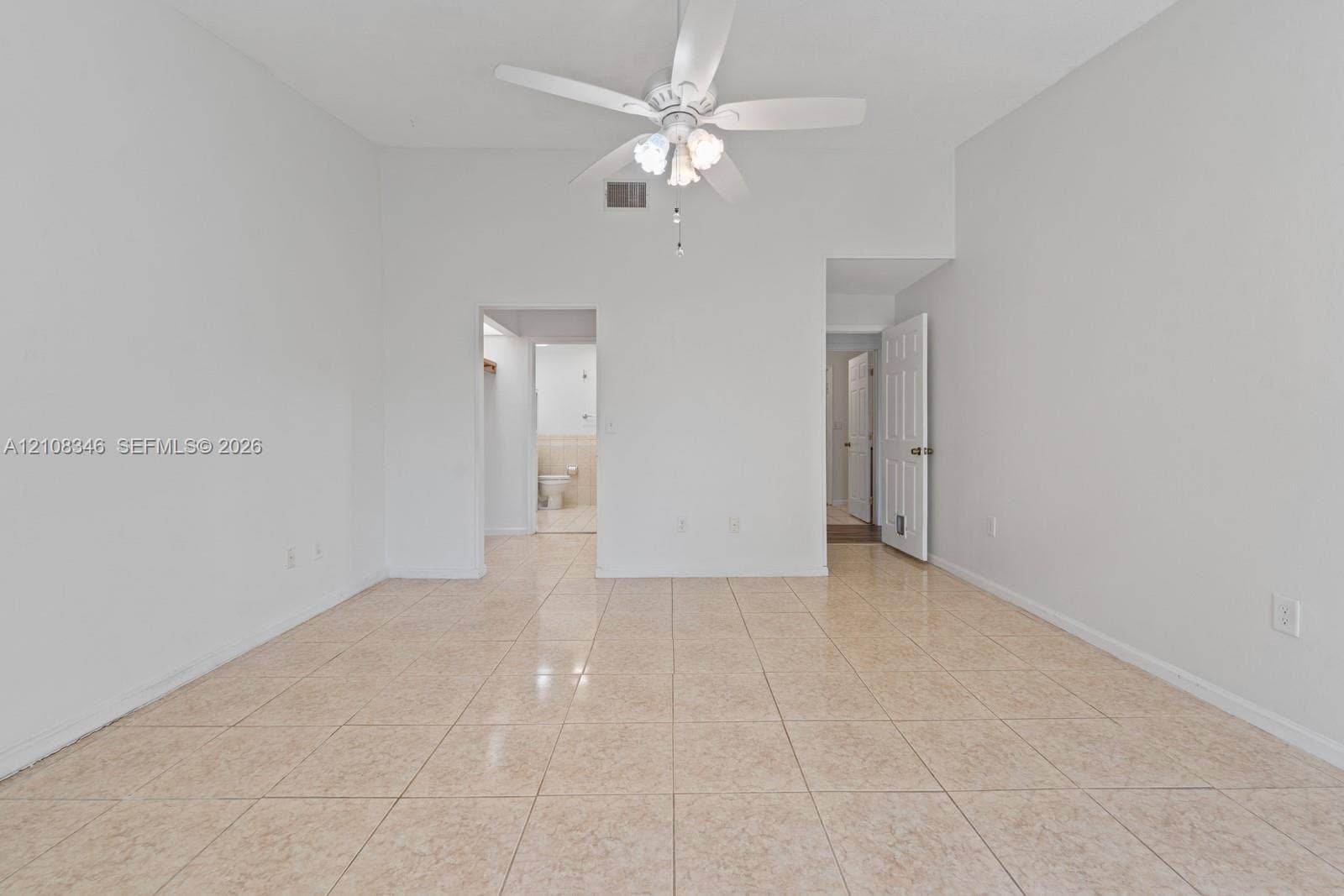 2530 SE 7th Place, Homestead, FL 33033 Room featuring tile flooring, vaulted ceilings, and a ceiling-mounted light fixture with fan