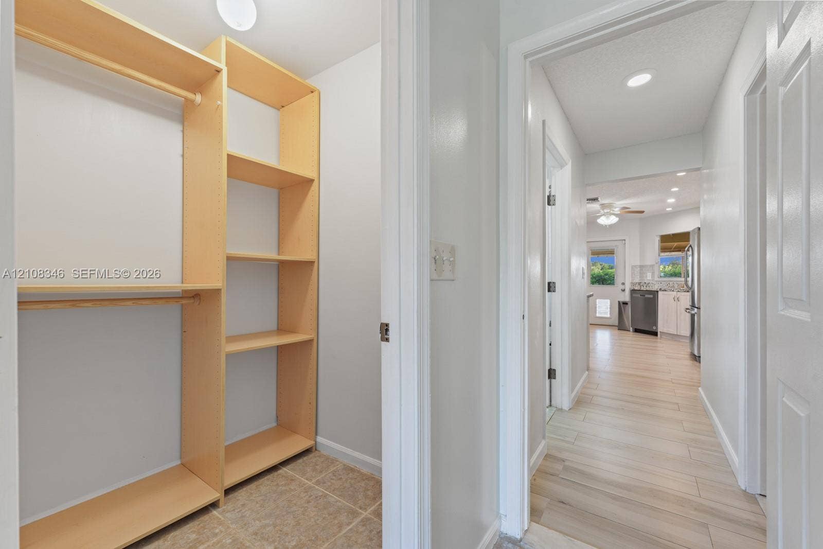 2530 SE 7th Place, Homestead, FL 33033 Built-in light-finish wood shelving, integrated hanging rods, recessed ceiling lighting, and wood-finish tile flooring