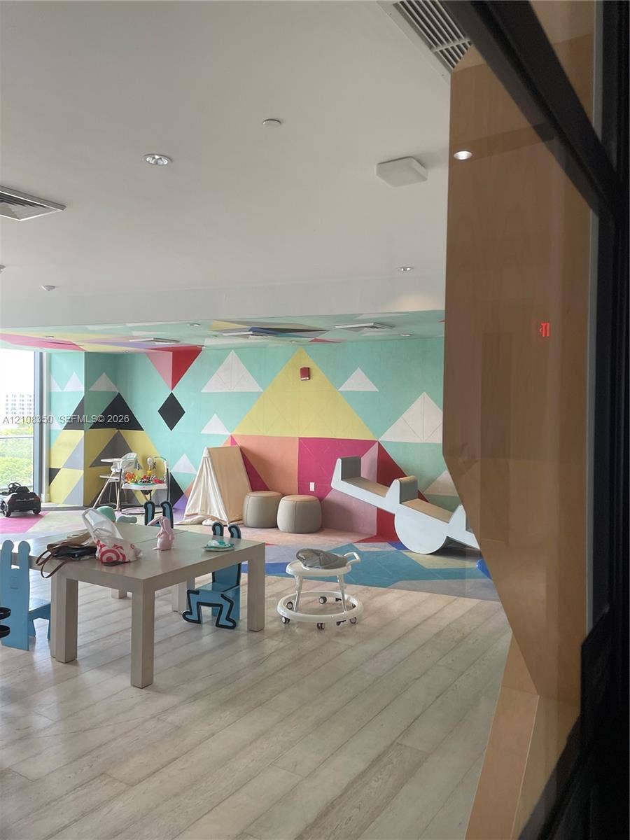 121 NE 34th Street, #1403, Miami, Miami, FL 33137 Common area featuring wood-finish flooring, recessed ceiling lighting, and geometric mural wall covering