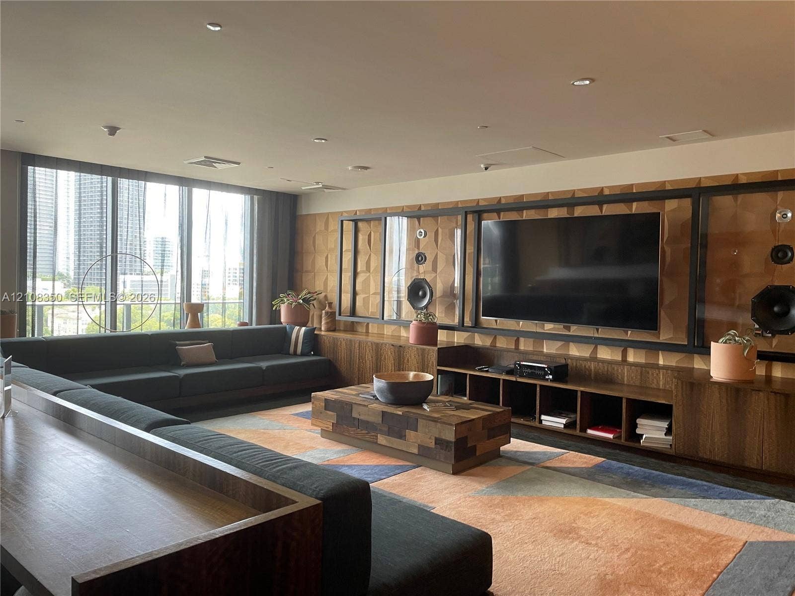 121 NE 34th Street, #1403, Miami, Miami, FL 33137 Floor-to-ceiling windows, custom built-in wood cabinetry with integrated shelving, geometric textured wall paneling, and recessed lighting