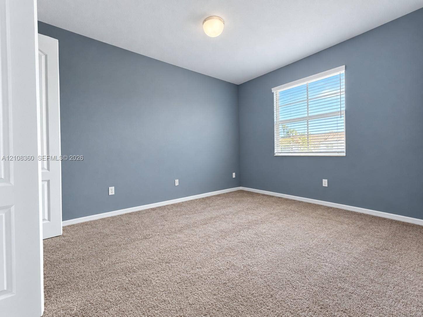 4608 Tara Cove Way, #4608, West Palm Beach, West Palm Beach, FL 33417 Neutral-toned walls, wall-to-wall carpeting, single-hung window with blinds, flush-mount ceiling light fixture, and six-panel interior door