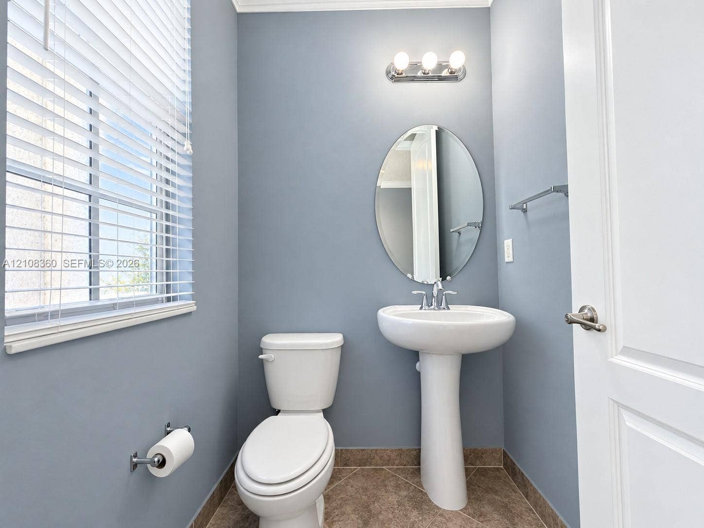 4608 Tara Cove Way, #4608, West Palm Beach, West Palm Beach, FL 33417 White pedestal sink with chrome faucet, oval wall-mounted mirror, three-light vanity fixture, and tile flooring