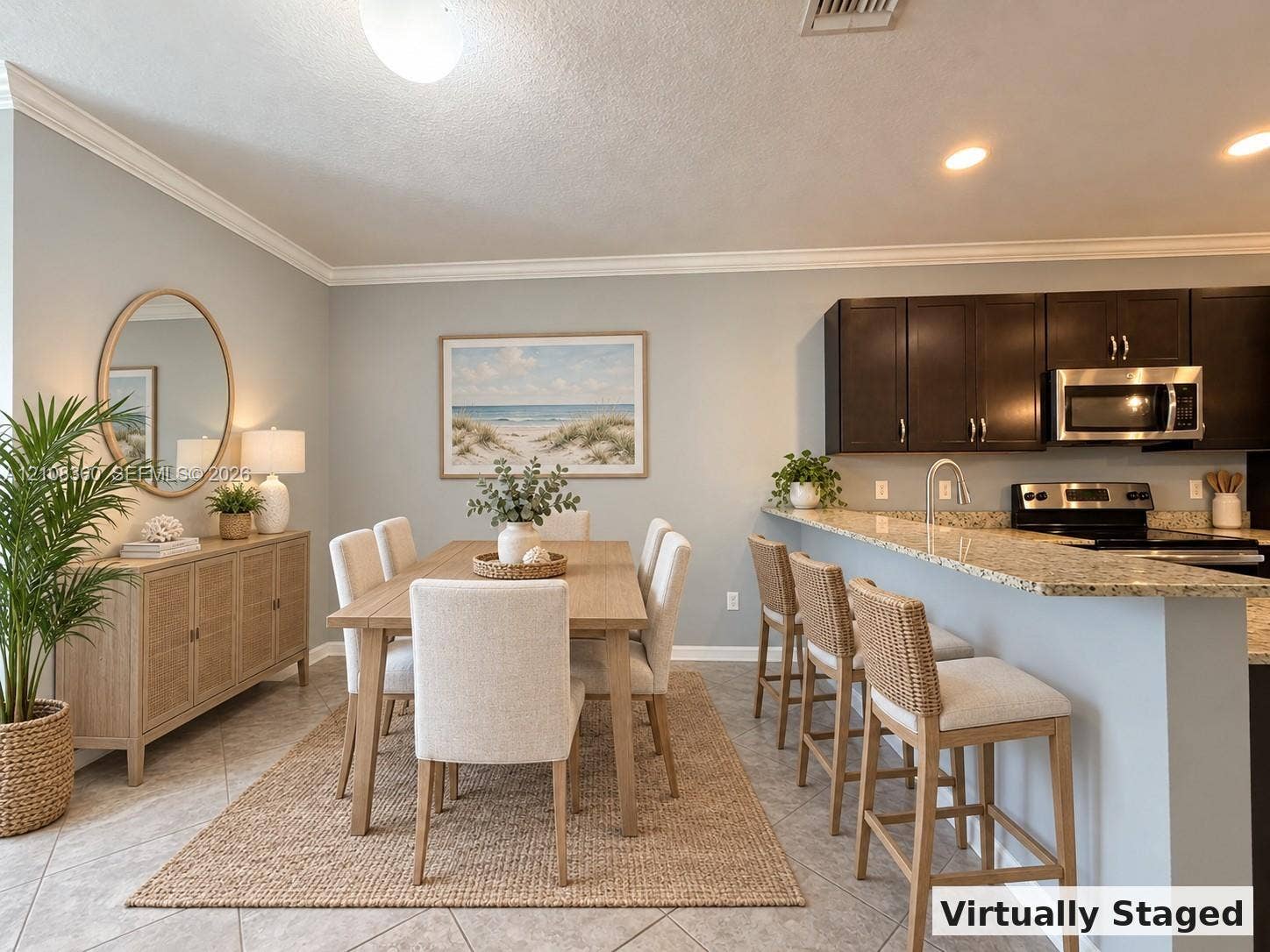 4608 Tara Cove Way, #4608, West Palm Beach, West Palm Beach, FL 33417 Kitchen featuring dark cabinetry, stone-surface breakfast bar, and stainless steel appliances, complemented by tile flooring and crown molding