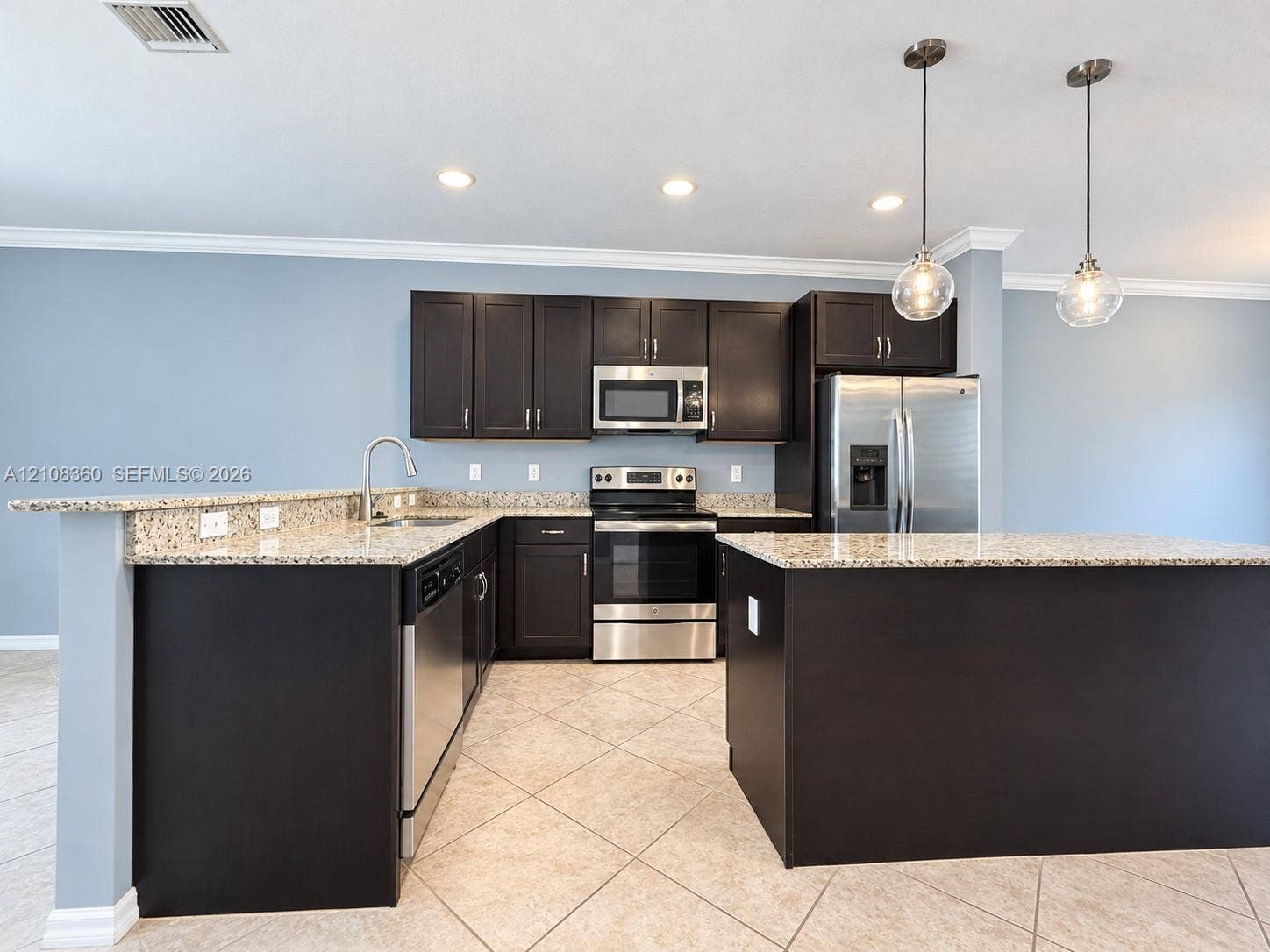 4608 Tara Cove Way, #4608, West Palm Beach, West Palm Beach, FL 33417 Kitchen featuring dark wood cabinetry, stone countertops, stainless steel appliances, a peninsula island, and globe pendant lighting