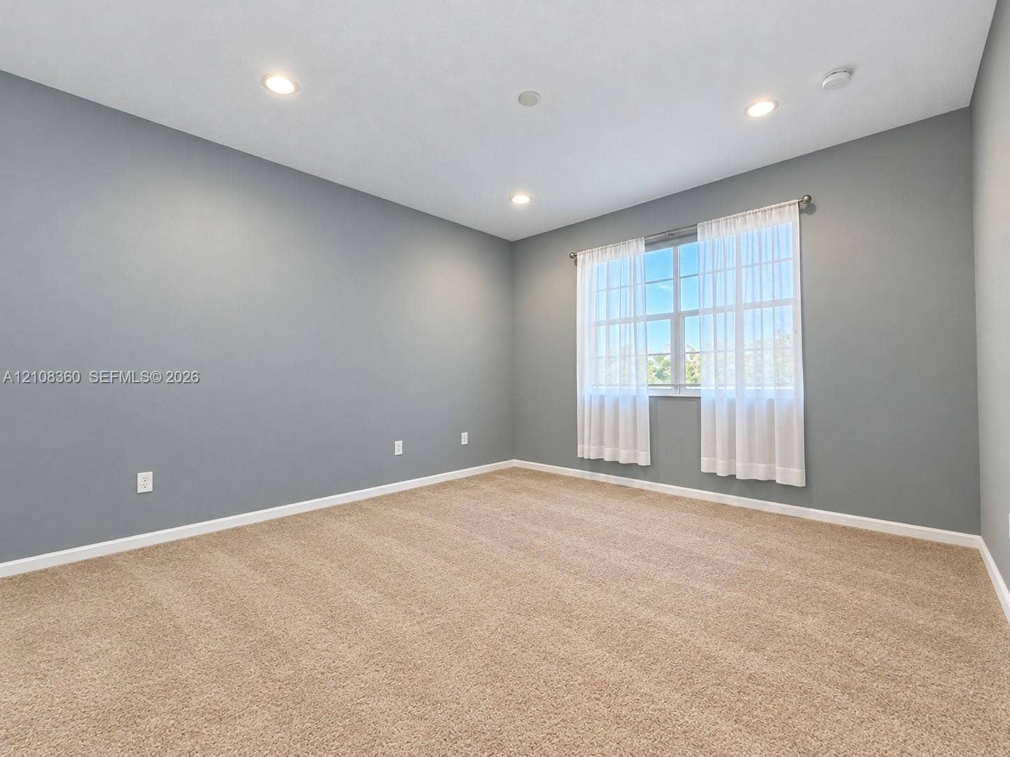 4608 Tara Cove Way, #4608, West Palm Beach, West Palm Beach, FL 33417 Neutral-toned interior space featuring recessed ceiling lighting, wall-to-wall carpeting, and a multi-pane window