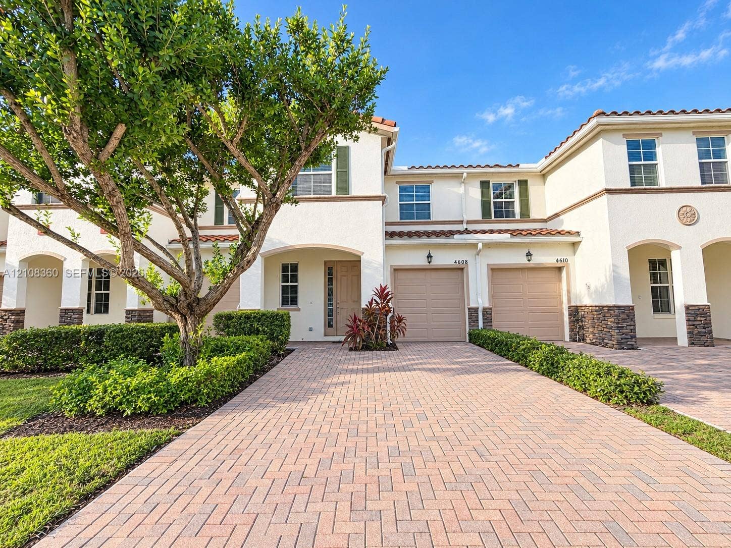 4608 Tara Cove Way, #4608, West Palm Beach, West Palm Beach, FL 33417 Stucco exterior featuring stone veneer accents, paver driveway, tile roofing, and attached two-car garages
