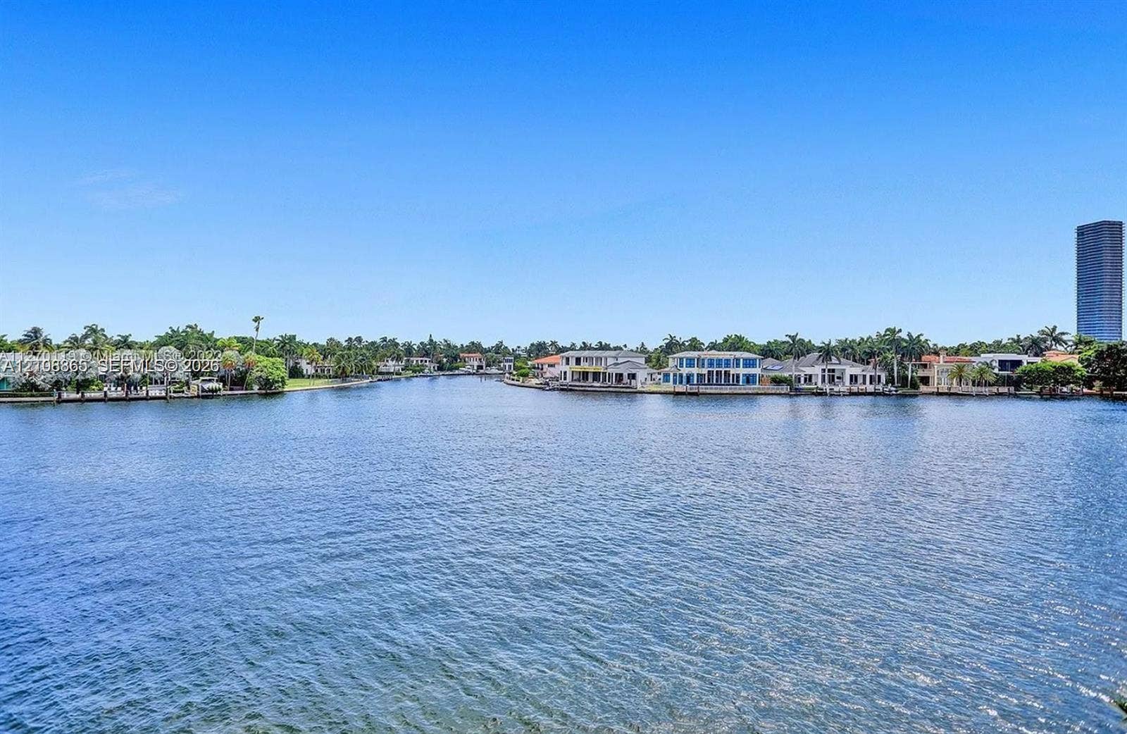 20165 NE 39 Place, #403, Aventura, FL 33180 Waterfront parcel featuring extensive canal frontage, deep-water access, and tropical landscape