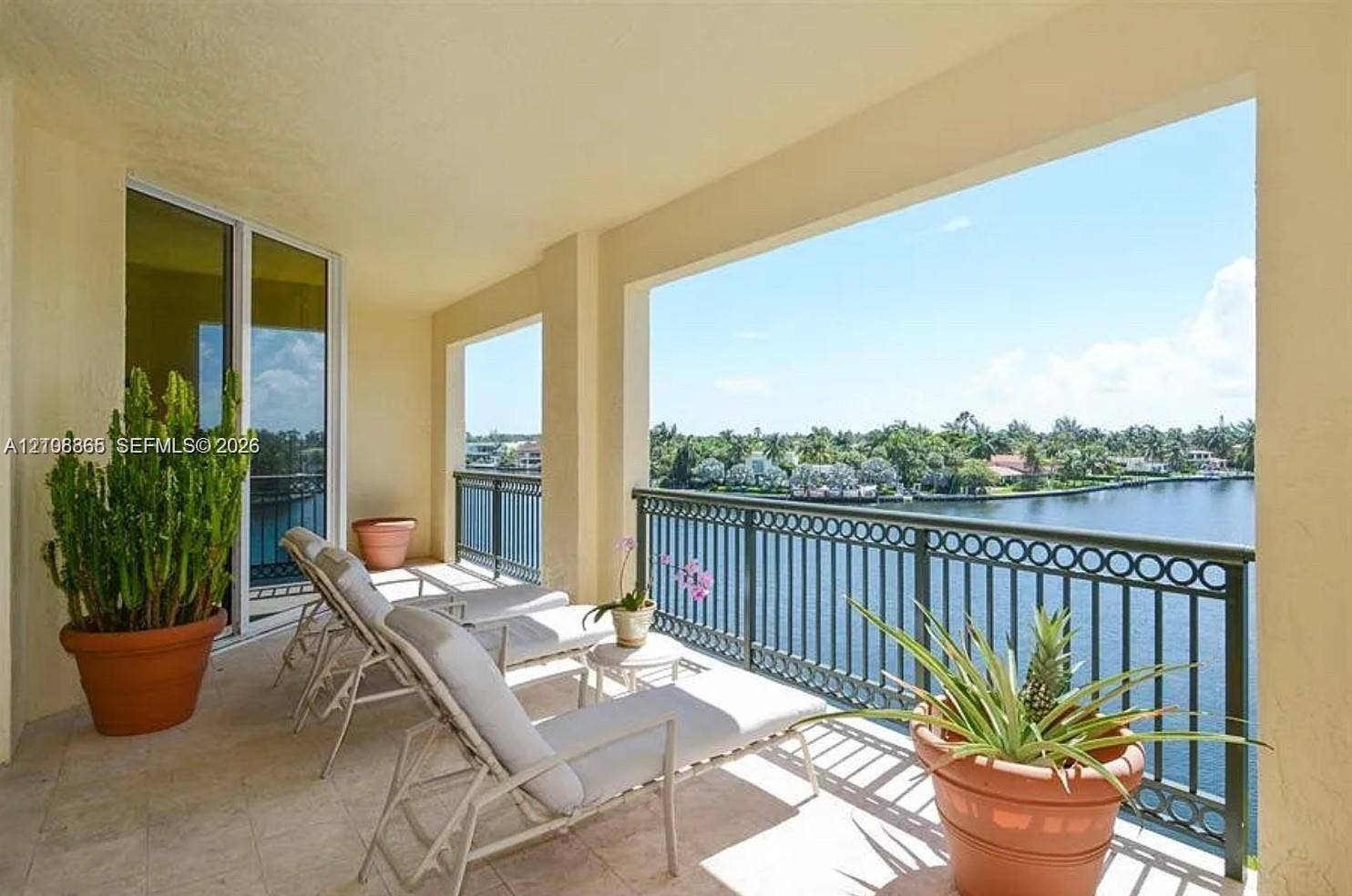 20165 NE 39 Place, #403, Aventura, FL 33180 Covered balcony featuring stone-finish tile flooring and ornate metal railings