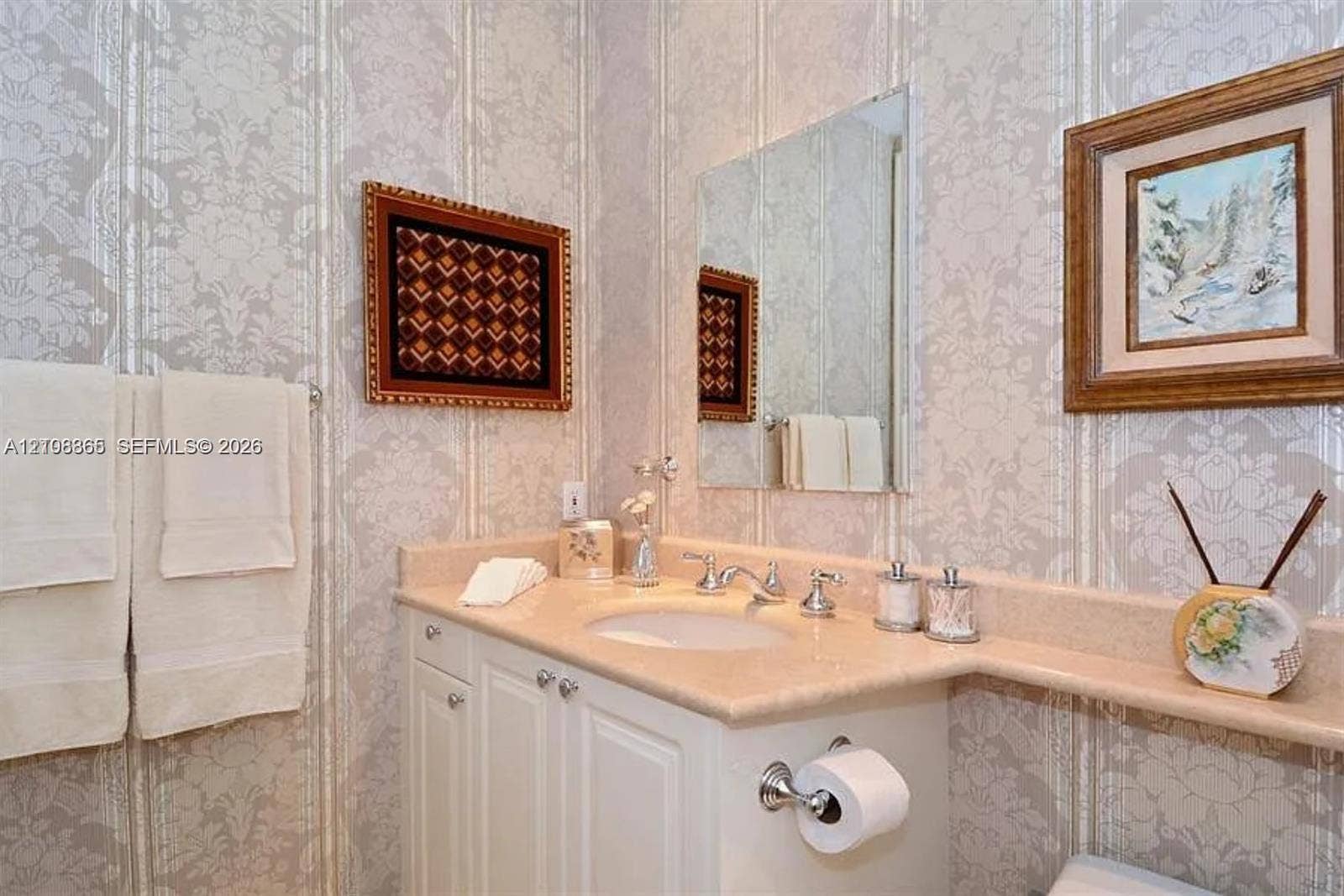 20165 NE 39 Place, #403, Aventura, FL 33180 Custom vanity with integrated countertop and backsplash, undermount sink, dual-handle chrome faucet, and wall-mounted mirror