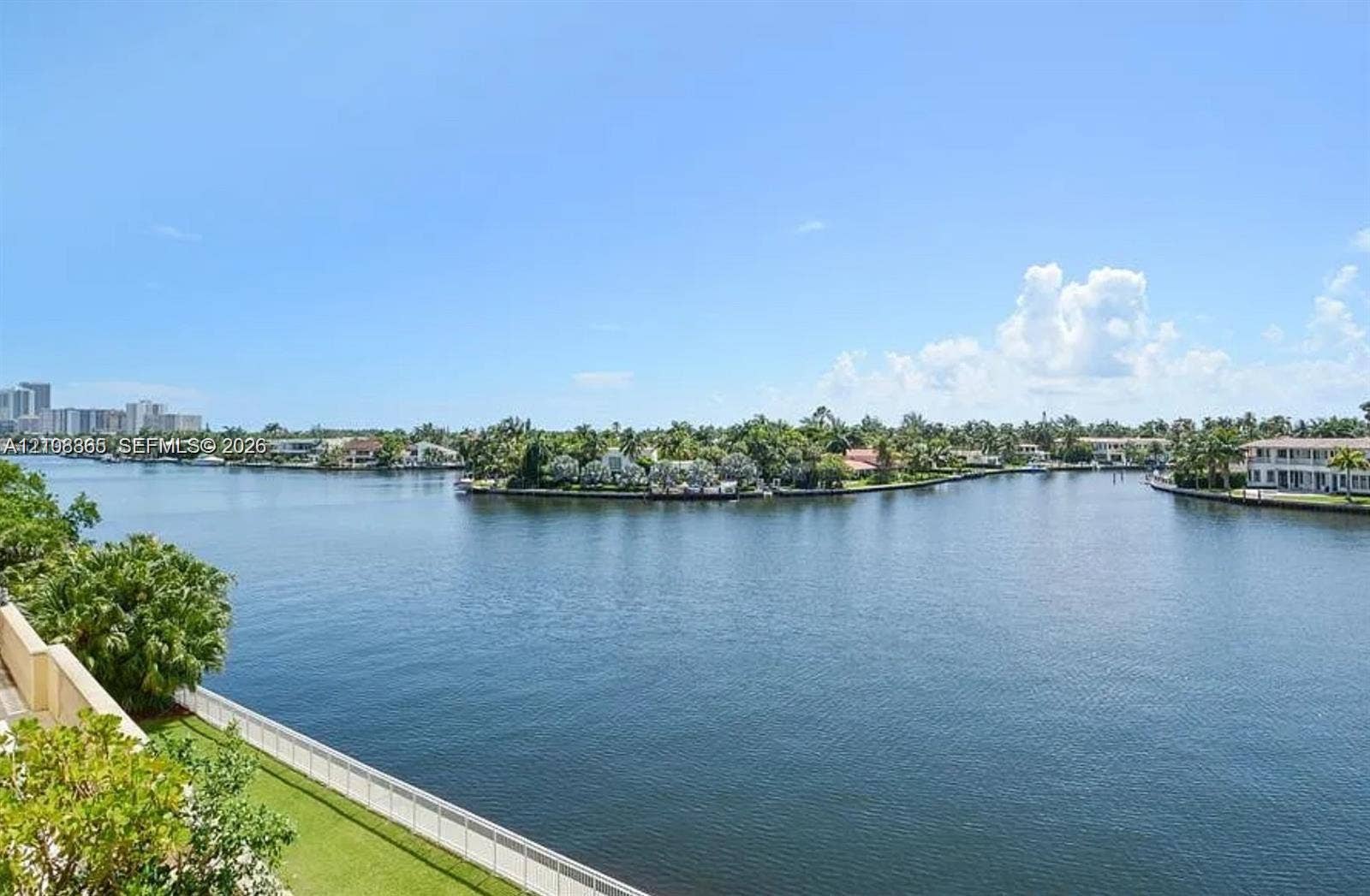 20165 NE 39 Place, #403, Aventura, FL 33180 Waterfront perspective featuring a wide canal, bulkhead seawall, and landscaped perimeter