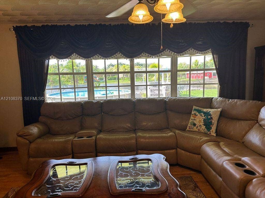18901 SW 63rd Street, Southwest Ranches, FL 33332 Large grid-style windows with multi-pane glass and a ceiling-mounted light fixture with three glass shades