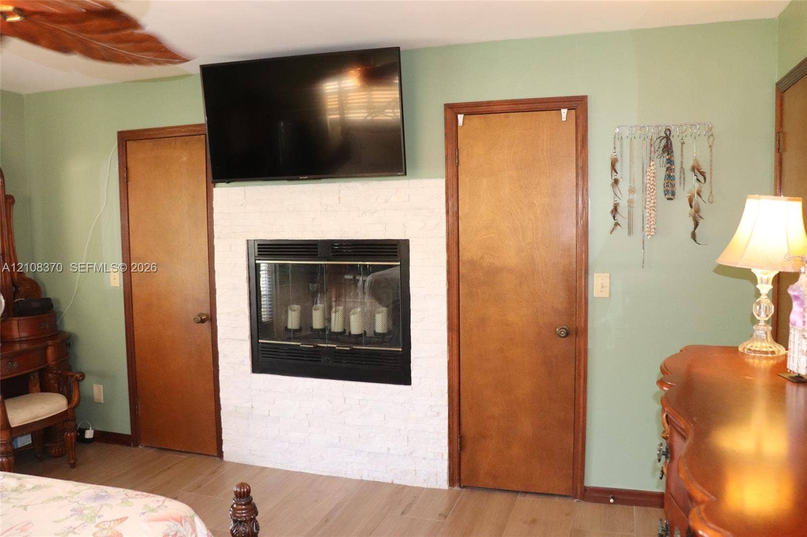 18901 SW 63rd Street, Southwest Ranches, FL 33332 White painted brick fireplace surround, inset firebox, and wood-finish flooring