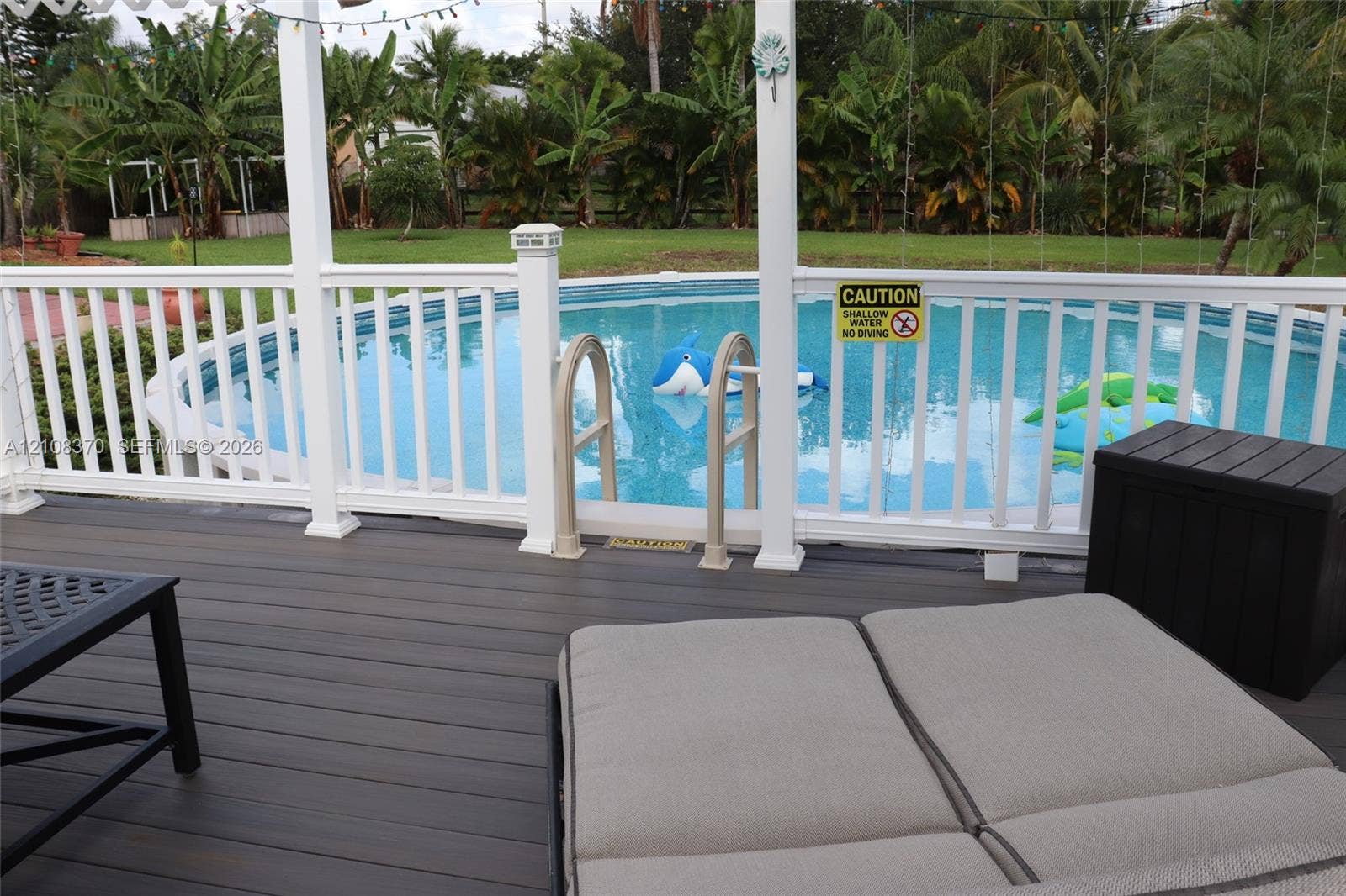 18901 SW 63rd Street, Southwest Ranches, FL 33332 Composite deck featuring a white railing enclosure and a circular above-ground pool