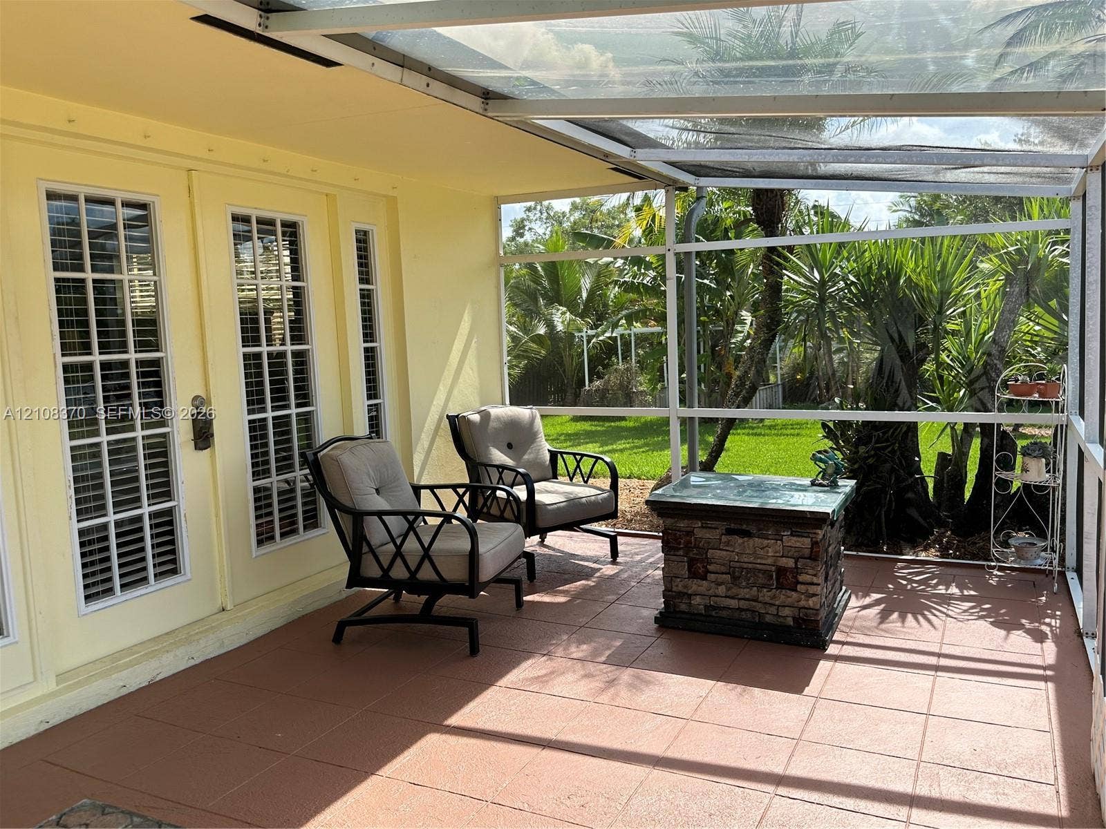18901 SW 63rd Street, Southwest Ranches, FL 33332 Screened-in porch featuring a tile floor, glass-paneled entry doors, and a transparent roof covering