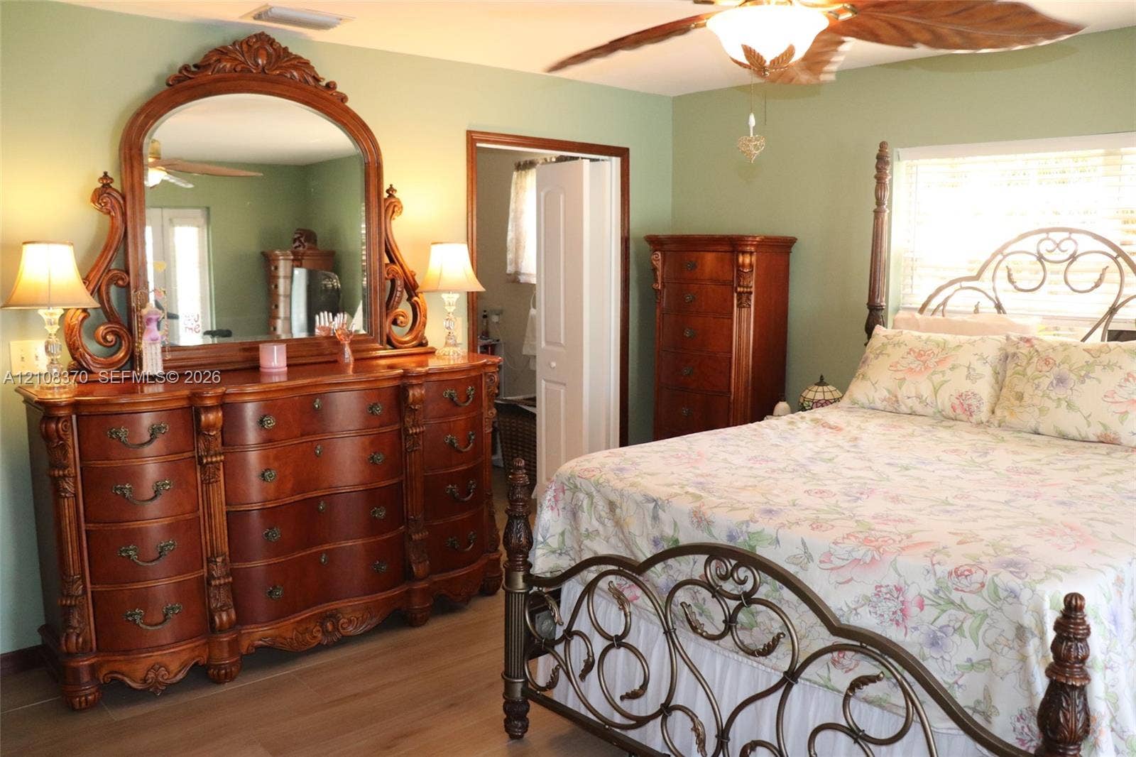 18901 SW 63rd Street, Southwest Ranches, FL 33332 Room featuring wood-finish flooring, a ceiling fan, and louvered closet doors