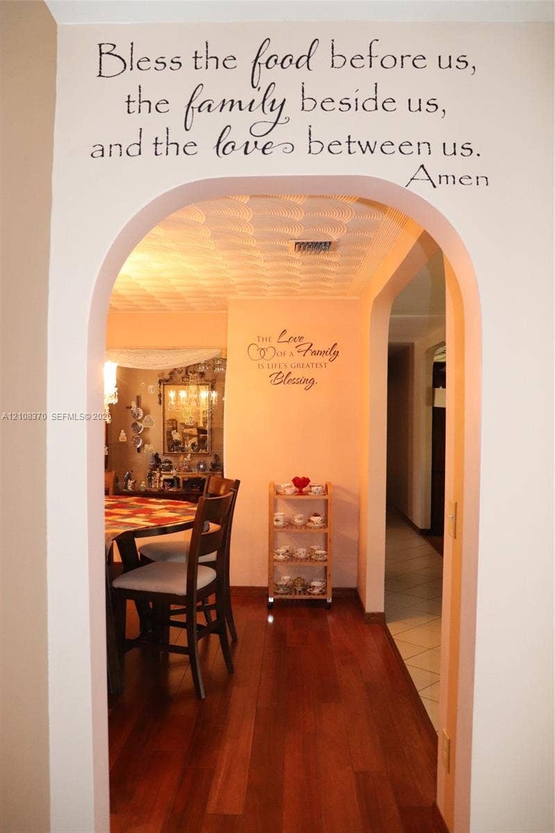 18901 SW 63rd Street, Southwest Ranches, FL 33332 Architectural arched doorway featuring wood-finish flooring and textured ceiling detail