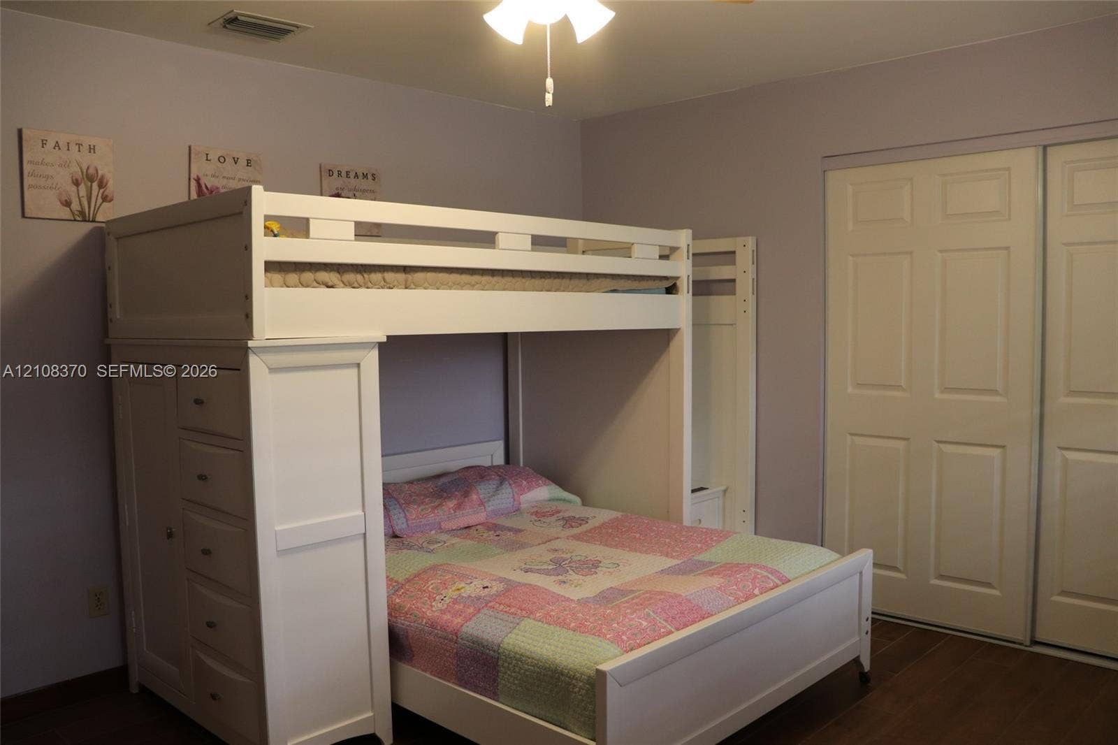 18901 SW 63rd Street, Southwest Ranches, FL 33332 Double-door closet with paneled trim, wood-finish flooring, and a ceiling-mounted light fixture
