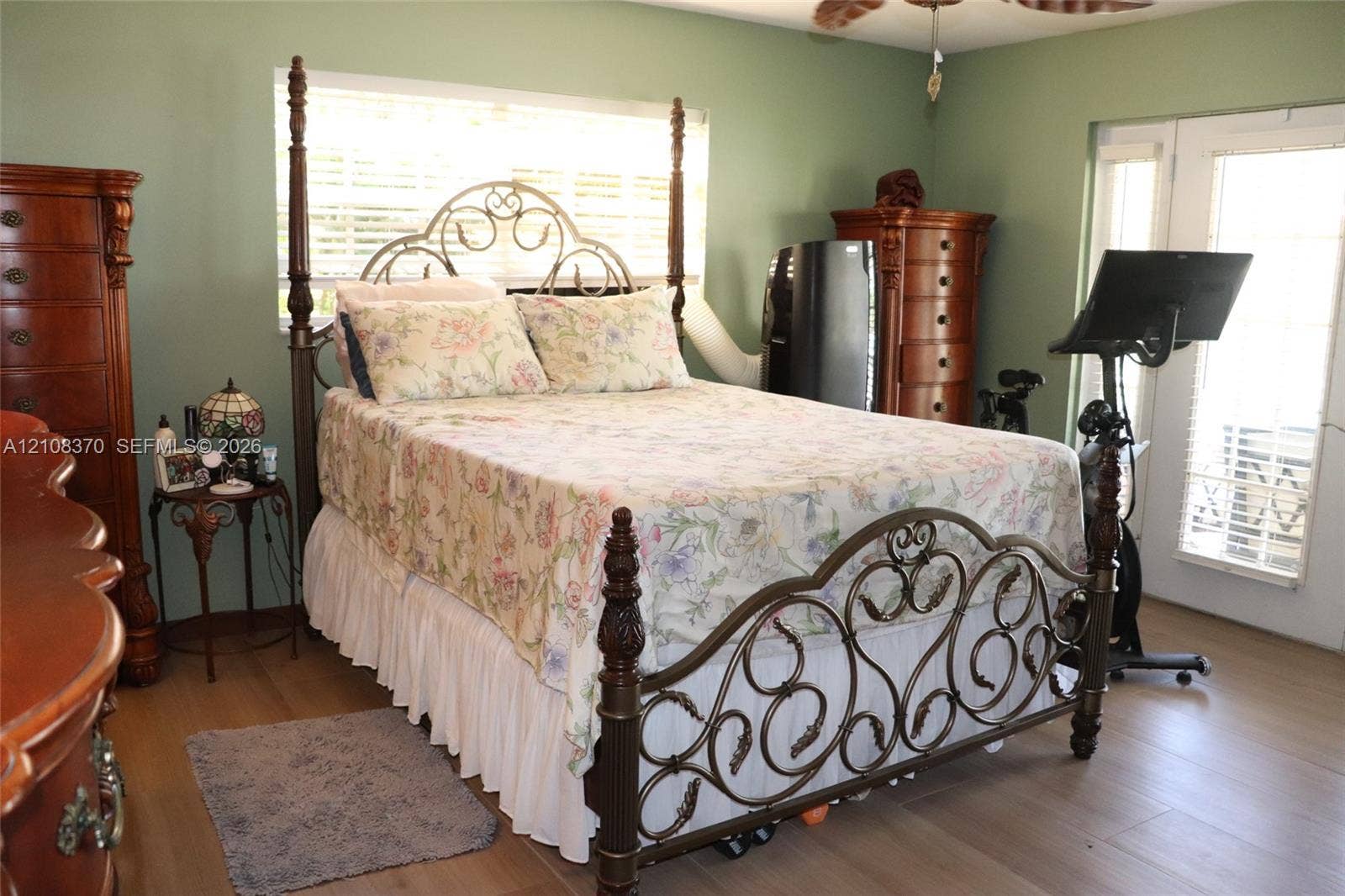 18901 SW 63rd Street, Southwest Ranches, FL 33332 Wood-finish flooring, ceiling fan with integrated light fixture, window with horizontal blinds, and glass-paneled entry door