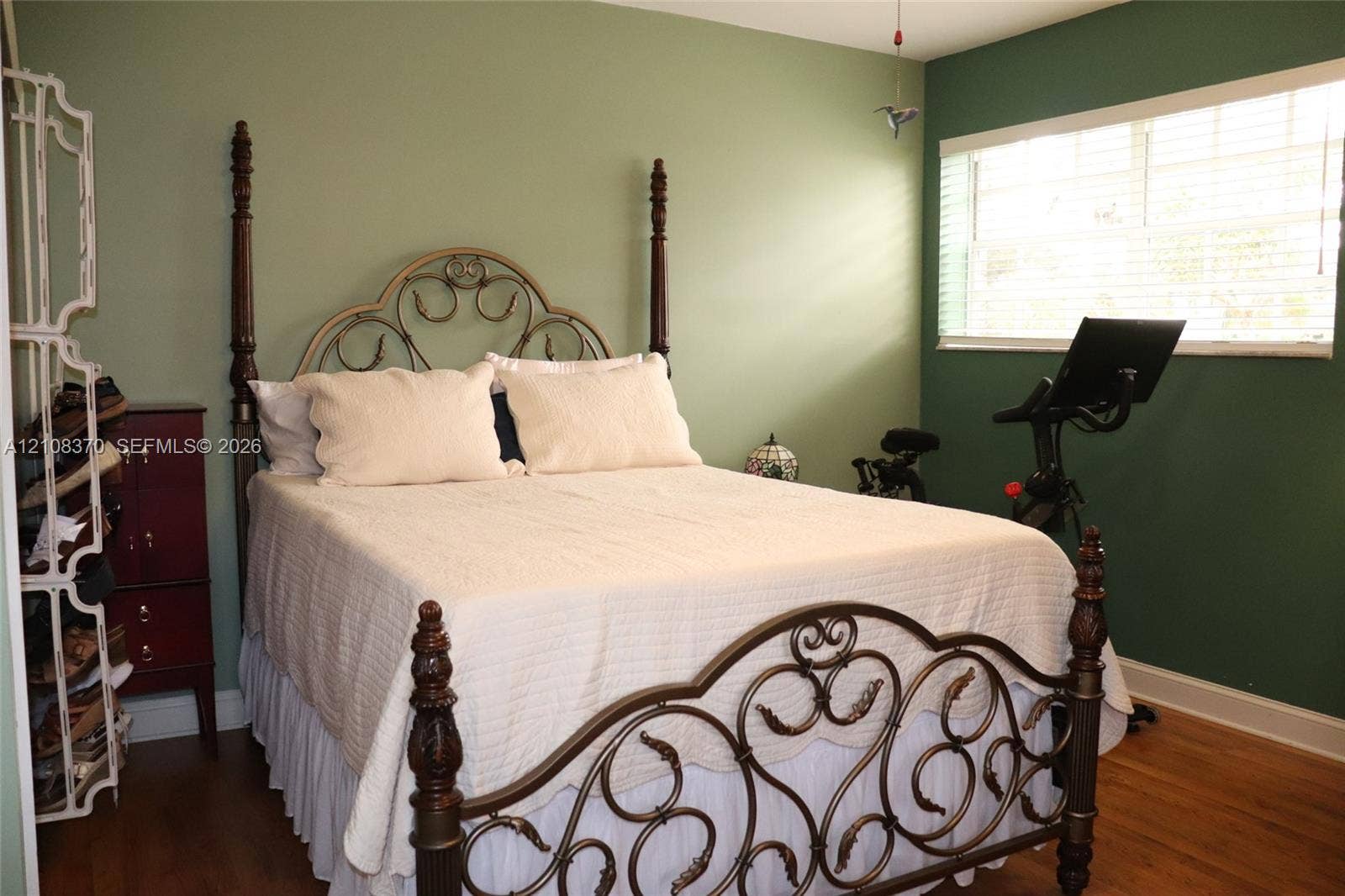18901 SW 63rd Street, Southwest Ranches, FL 33332 Wood-finish flooring, two-tone painted walls, and a large window featuring horizontal blinds
