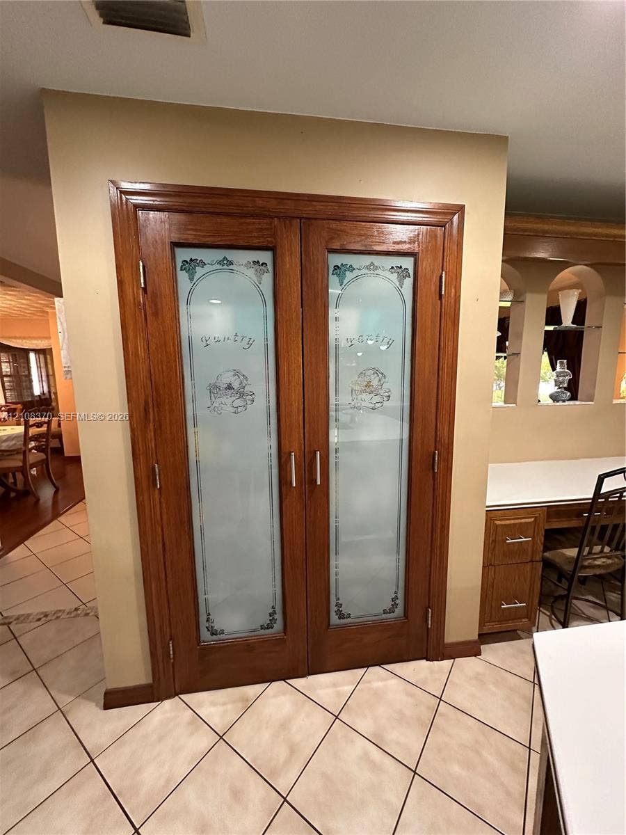 18901 SW 63rd Street, Southwest Ranches, FL 33332 Double pantry doors featuring wood framing and decorative etched glass inserts with silver-tone hardware