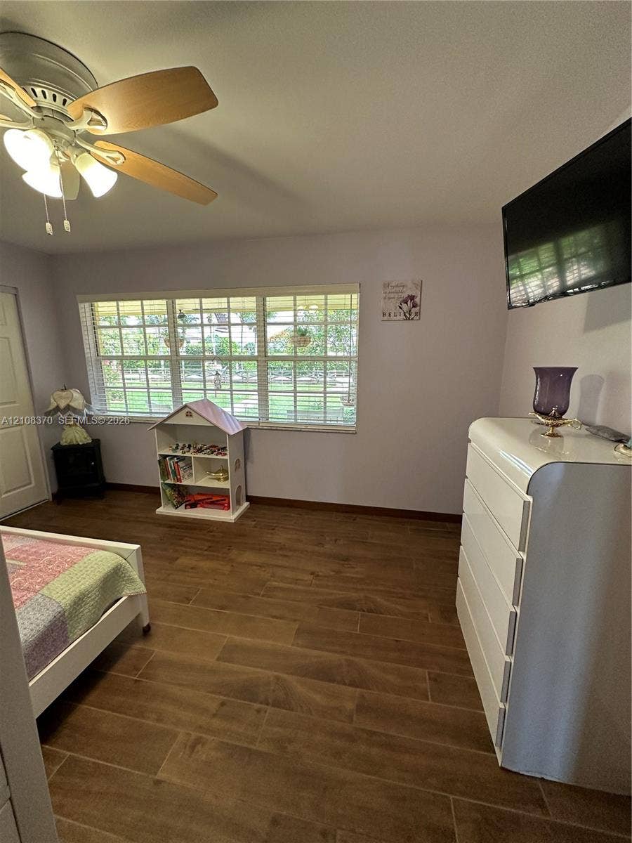 18901 SW 63rd Street, Southwest Ranches, FL 33332 Wood-finish flooring, multi-pane windows, and a multi-light ceiling fan with integrated illumination