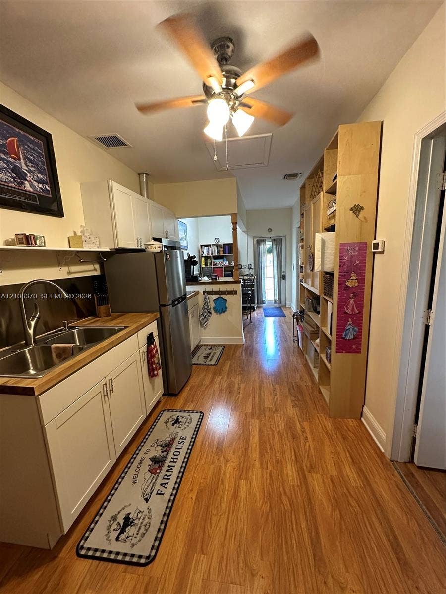 18901 SW 63rd Street, Southwest Ranches, FL 33332 Room featuring wood-finish flooring and a horizontal window with slatted blinds