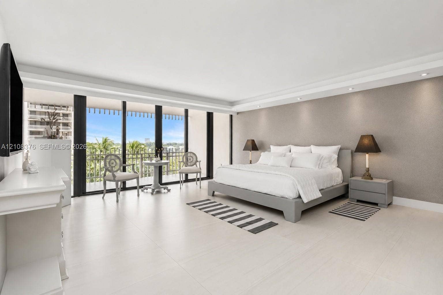 3 Grove Isle Drive, #C502, Miami, Miami, FL 33133 Large-format tile flooring, recessed ceiling lighting, crown molding, and floor-to-ceiling glass sliding doors opening to a covered balcony