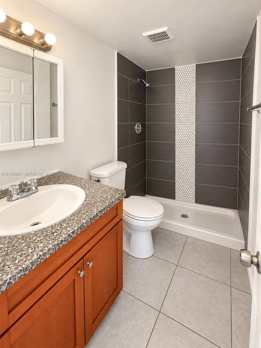621 NW 177th Street, #101, Miami Gardens, Miami Gardens, FL 33169 Neutral tile flooring, dual reach-in closets with six-panel doors, and a double-hung window with integrated blinds
