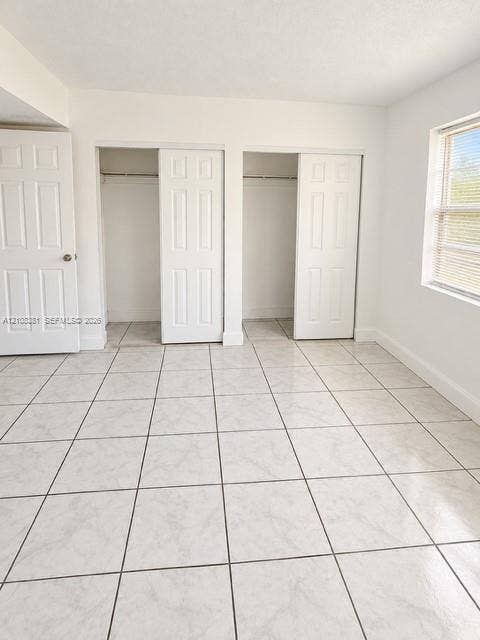 621 NW 177th Street, #101, Miami Gardens, Miami Gardens, FL 33169 Bathroom featuring a vanity with speckled countertop and integrated oval sink, wood-finish cabinetry, shower stall with large-format dark tile and a central vertical mosaic accent, and neutral floor tile