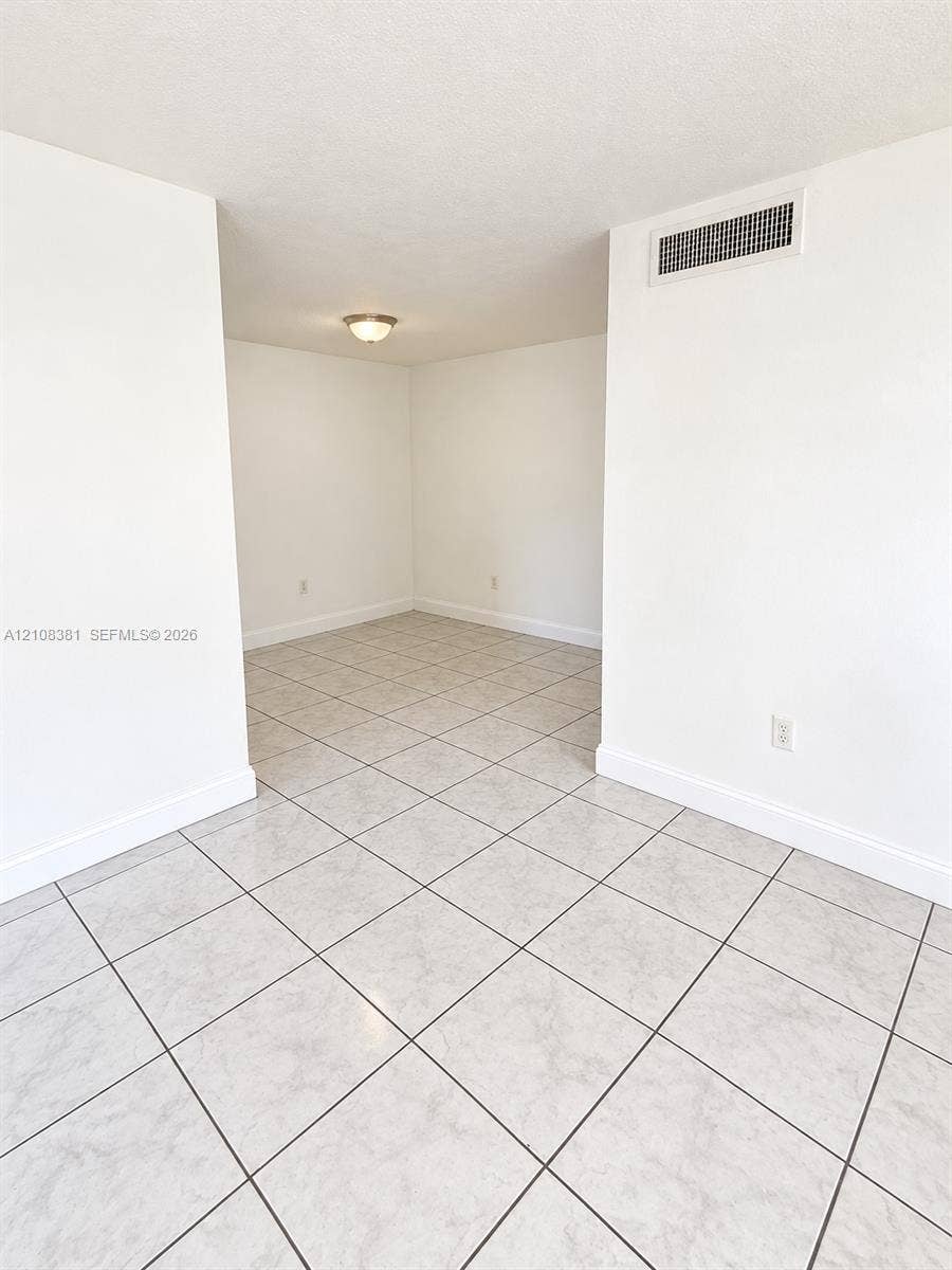 621 NW 177th Street, #101, Miami Gardens, Miami Gardens, FL 33169 Neutral-toned ceramic tile flooring, crisp white walls, and a center-mounted flush mount light fixture