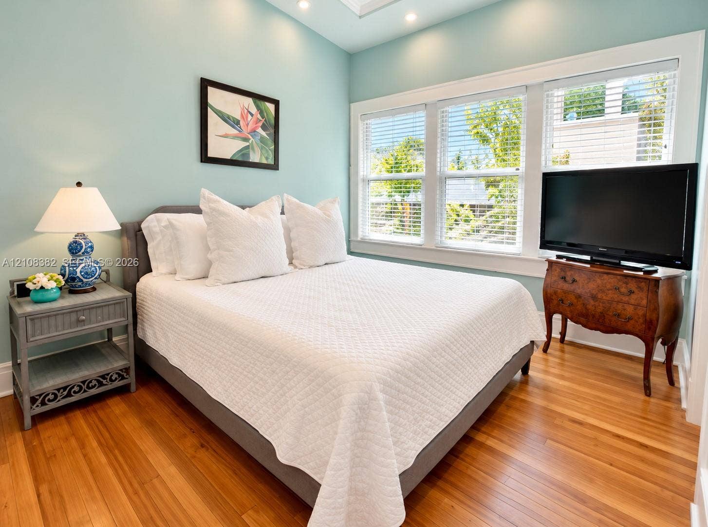 1701 S Olive Avenue, West Palm Beach, FL 33401 Wood-finish flooring, recessed ceiling lighting, and expansive triple-window configuration with white trim