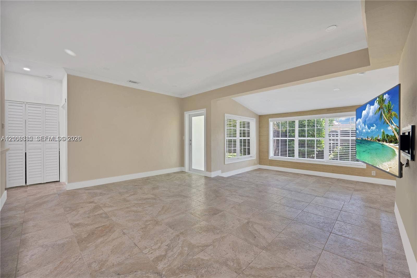 818 NE 3rd Street, Hallandale Beach, Hallandale Beach, FL 33009 Neutral tile flooring, recessed lighting, crown molding, multi-pane windows, and white louvered closet doors
