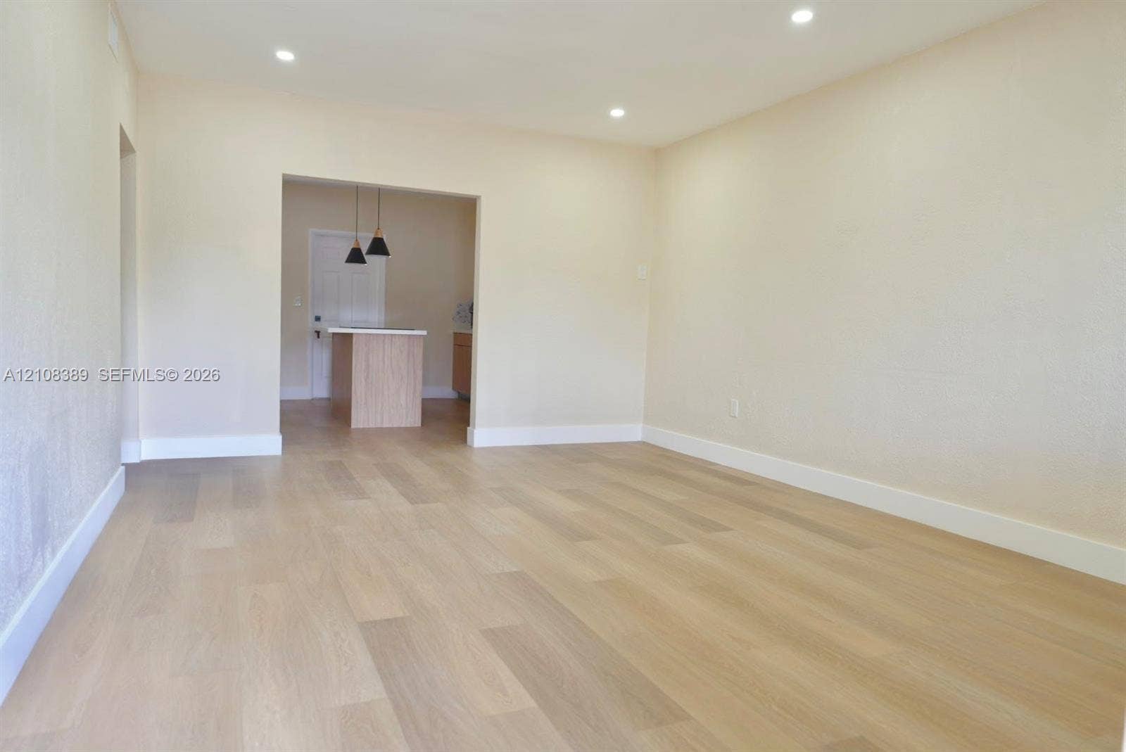Neutral-toned interior featuring wood-finish flooring and recessed ceiling lighting
