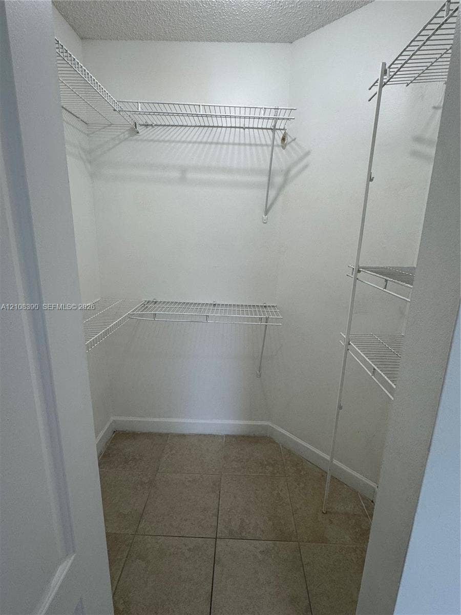 18346 NW 68th Avenue, #K, Hialeah, Hialeah, FL 33015 Walk-in storage space featuring ceramic tile flooring and multi-level wire shelving