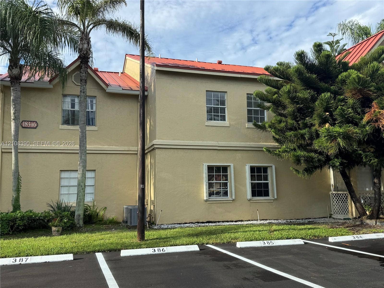 18346 NW 68th Avenue, #K, Hialeah, Hialeah, FL 33015 Two-story exterior featuring a metal roof, stucco siding, and double-hung windows