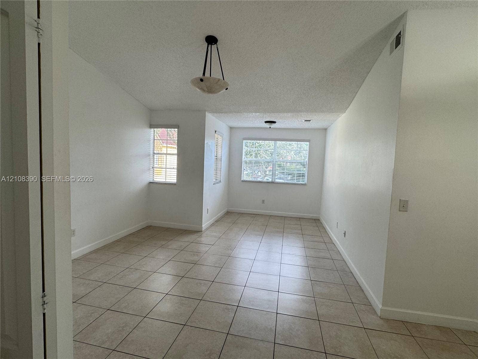 18346 NW 68th Avenue, #K, Hialeah, Hialeah, FL 33015 Vaulted ceilings featuring pendant lighting, ceramic tile flooring, and multiple windows with integrated blinds