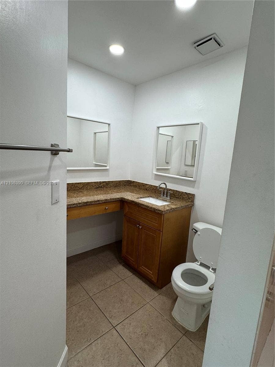 18346 NW 68th Avenue, #K, Hialeah, Hialeah, FL 33015 Bathroom featuring wood cabinetry, stone-finish countertop with an integrated basin, recessed lighting, and tile flooring