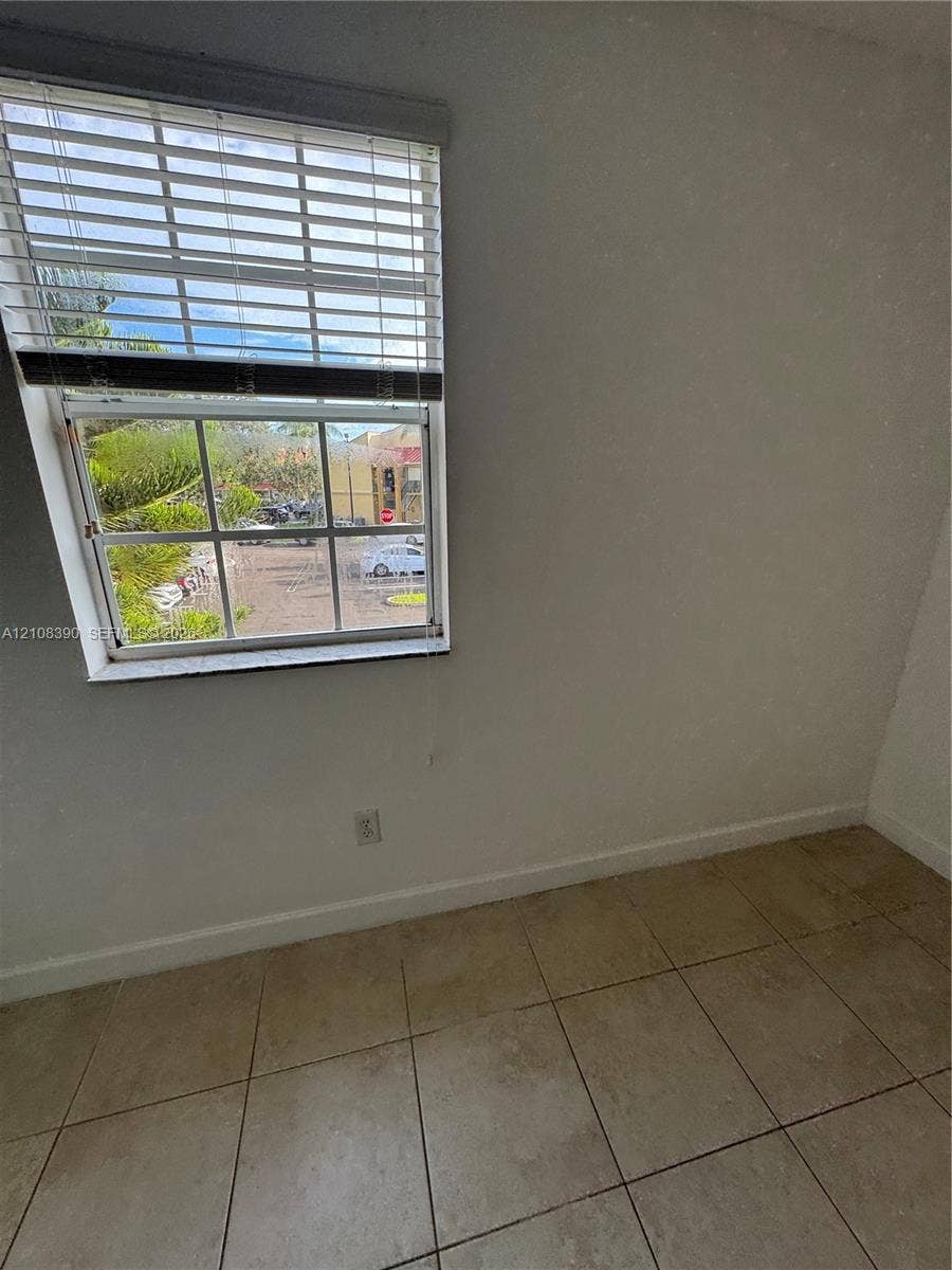 18346 NW 68th Avenue, #K, Hialeah, Hialeah, FL 33015 Multi-pane window featuring horizontal blinds and neutral-toned tile flooring