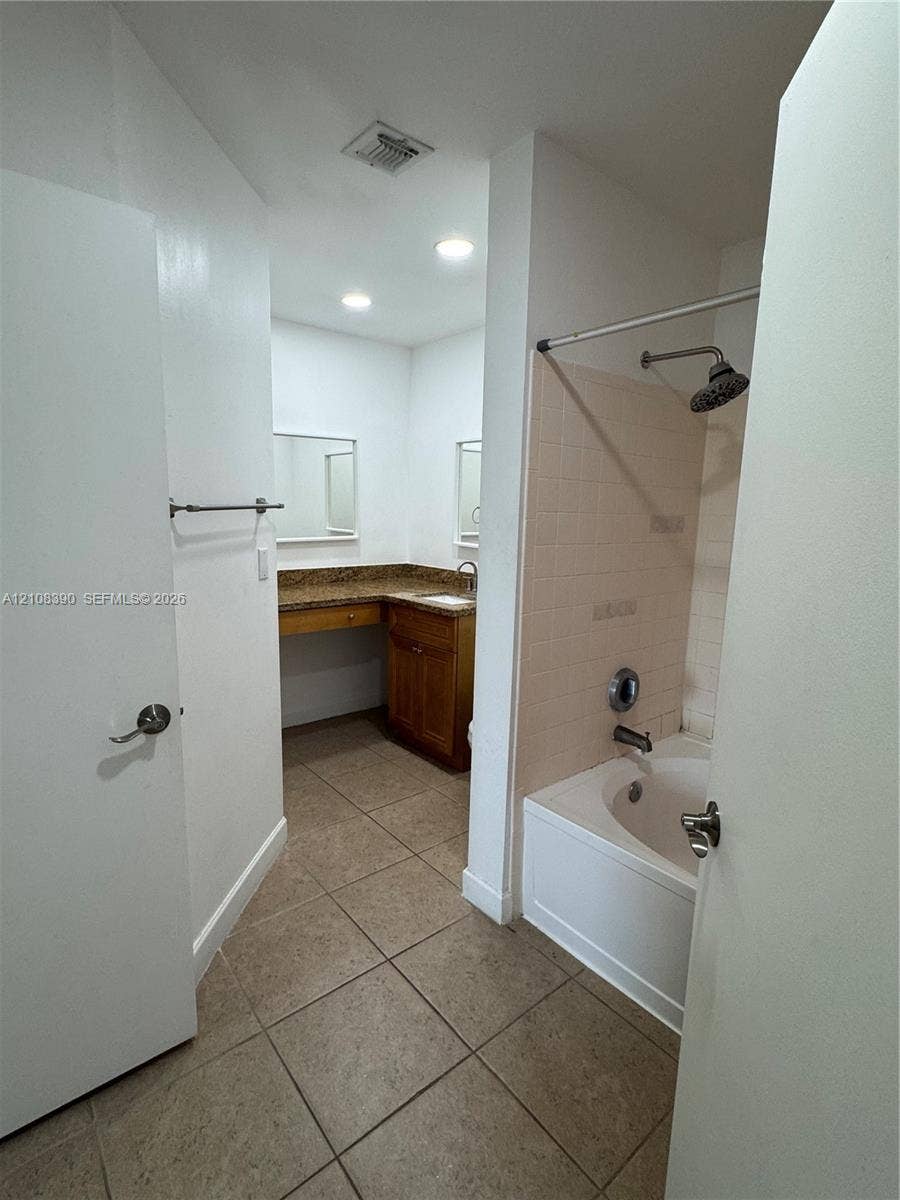 18346 NW 68th Avenue, #K, Hialeah, Hialeah, FL 33015 Bathroom featuring tiled flooring, a built-in vanity with stone countertop, recessed lighting, and a bathtub with a tiled surround