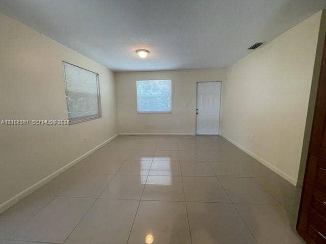 18233 Oleta Drive, #18233, North Miami Beach, North Miami Beach, FL 33160 Neutral-toned tile flooring, recessed ceiling lighting, and multiple windows providing natural light