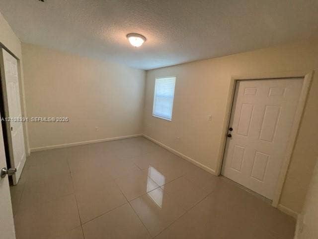 18233 Oleta Drive, #18233, North Miami Beach, North Miami Beach, FL 33160 Large-format tile flooring, neutral wall tones, single-hung window, and six-panel interior and exterior doors