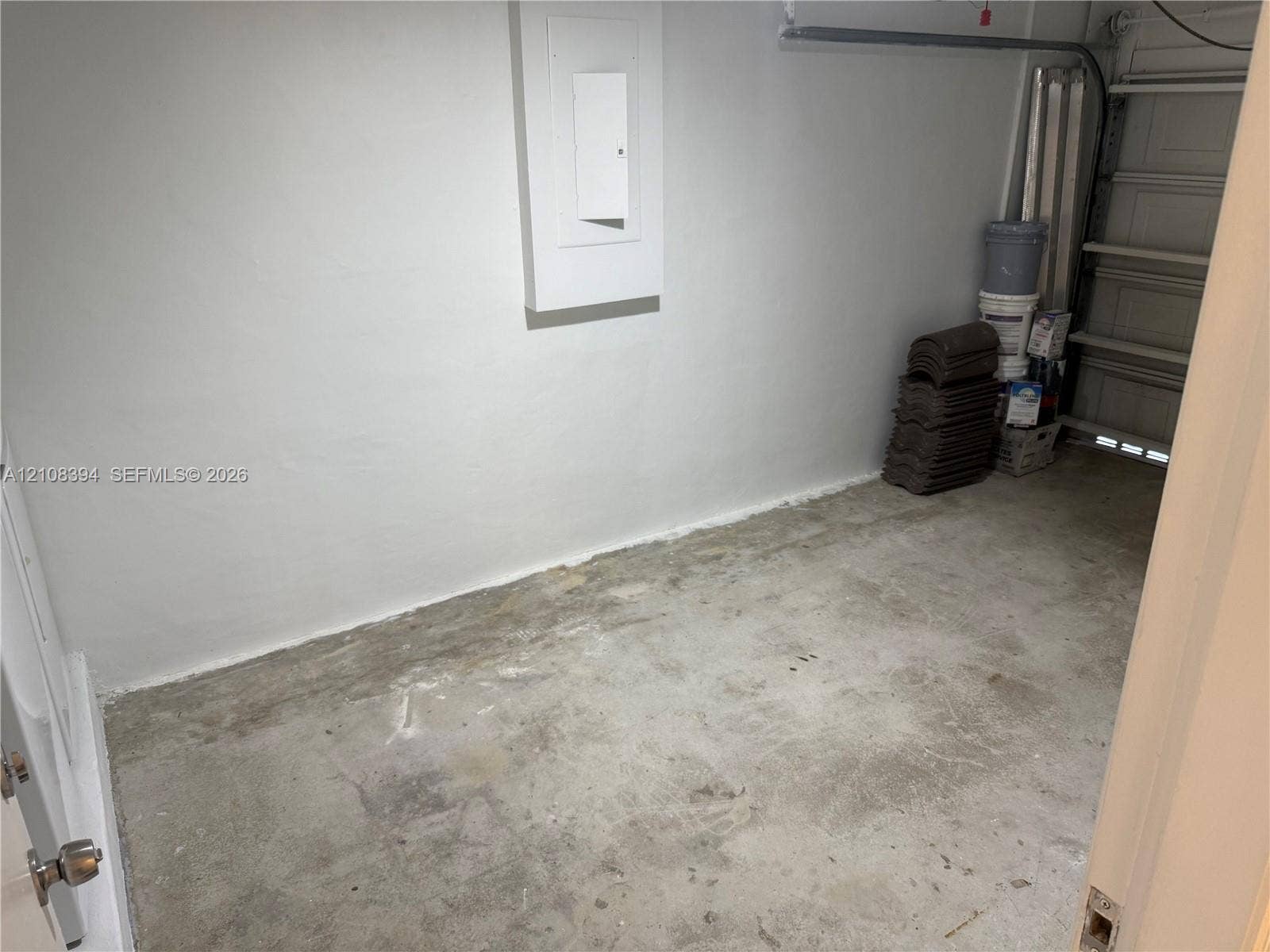 14781 SW 156th Avenue, Miami, Miami, FL 33196 Enclosed storage area featuring concrete flooring, smooth wall finish, and an integrated electrical panel