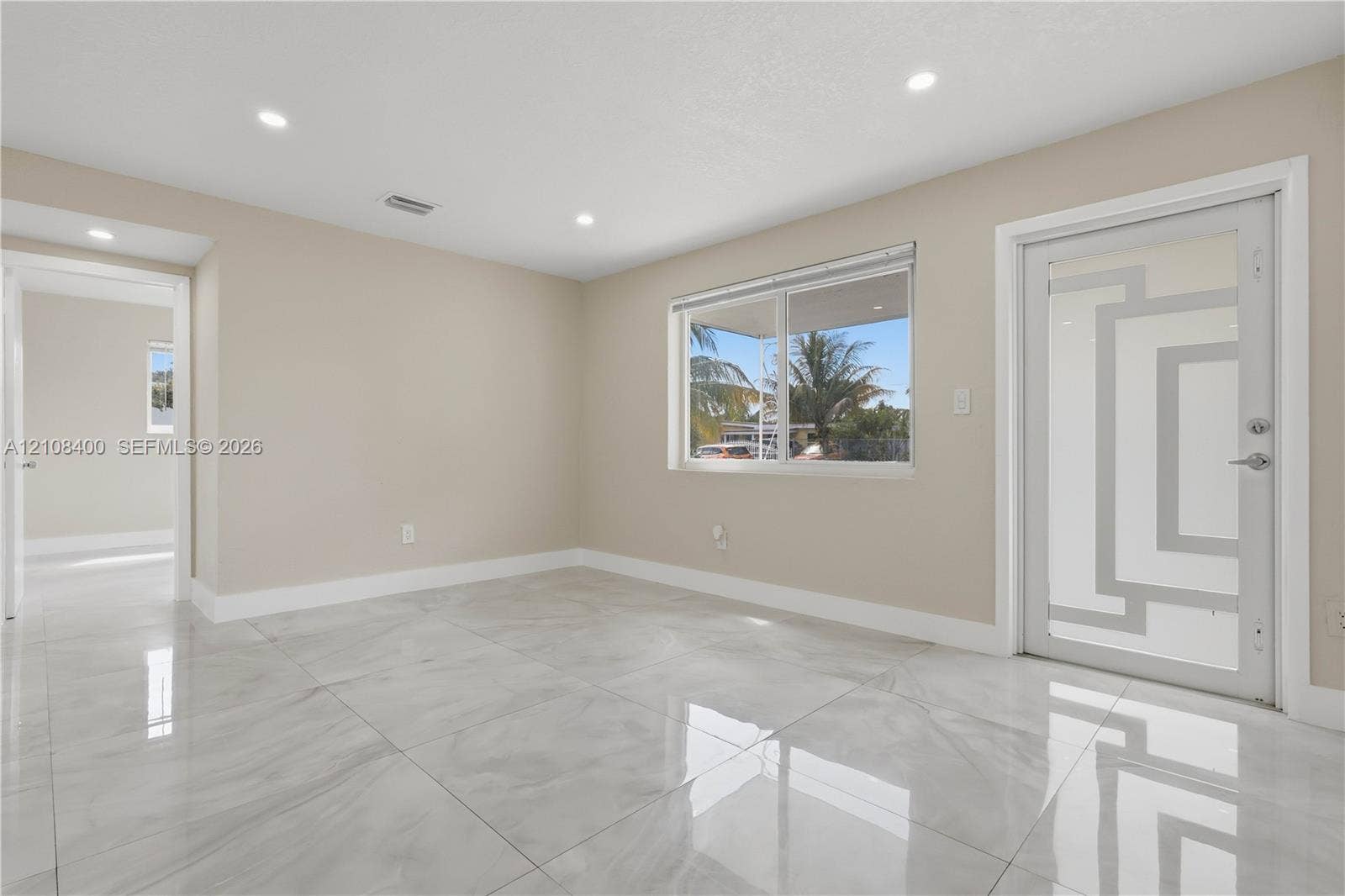 2551 SW 53rd Avenue, West Park, West Park, FL 33023 Polished stone-finish flooring, recessed ceiling lighting, and exterior door with decorative glass insert