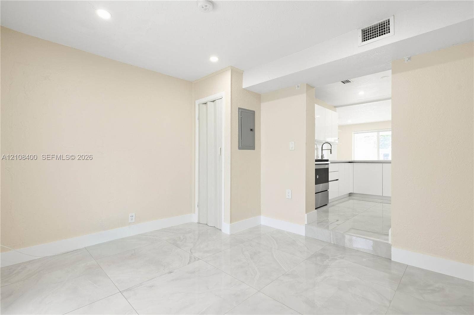 2551 SW 53rd Avenue, West Park, West Park, FL 33023 Interior space featuring polished stone-finish tile flooring, recessed ceiling lighting, and a neutral color palette