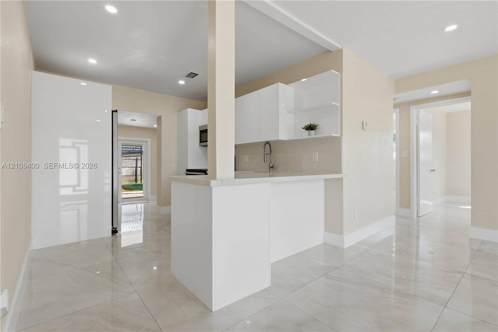 2551 SW 53rd Avenue, West Park, West Park, FL 33023 Kitchen featuring high-gloss white cabinetry, white stone countertops, polished tile flooring, and recessed ceiling lighting