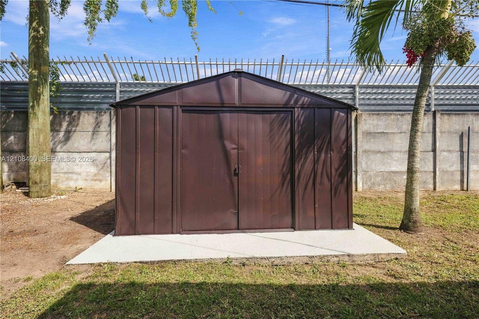 2551 SW 53rd Avenue, West Park, West Park, FL 33023 Metal storage structure featuring double doors situated on a concrete slab foundation