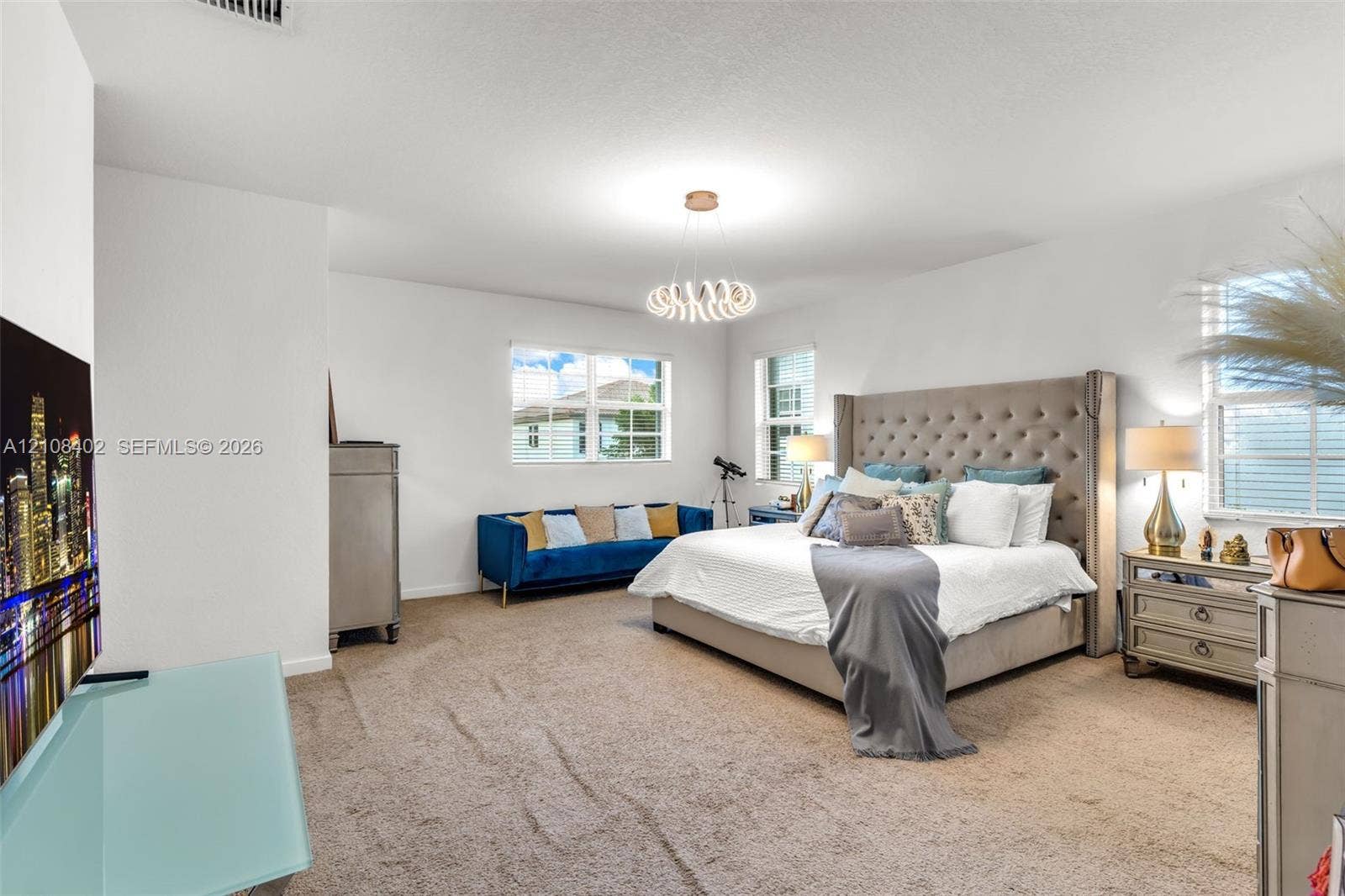 11771 SW 243rd Street, Homestead, FL 33032 Neutral wall finishes, plush carpeting, multi-pane windows, and a sculptural modern ceiling light fixture