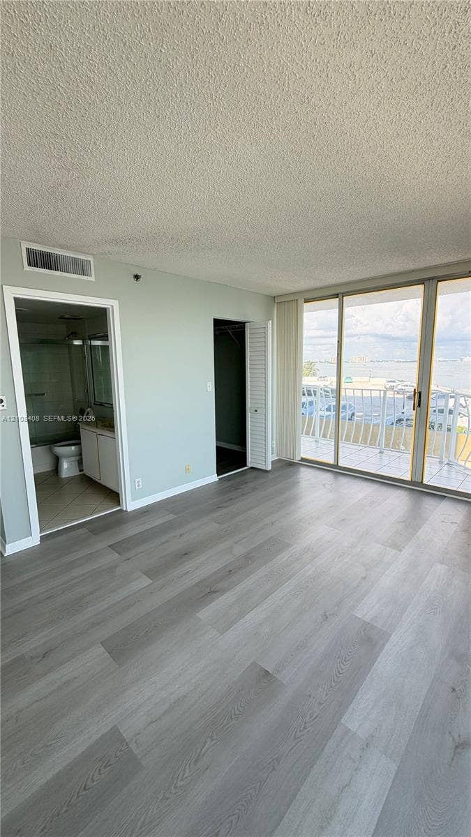 7601 E Treasure Drive, #618, North Bay Village, North Bay Village, FL 33141 Wood-finish flooring, full-height sliding glass doors with balcony access, and dual interior doorways
